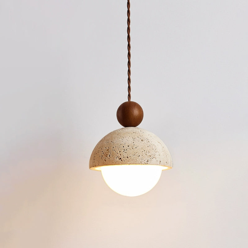 Vairo Travertine Dome Pendant Light hanging against a pale plaster wall
