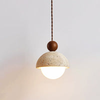 Vairo Travertine Dome Pendant Light hanging against a pale plaster wall
