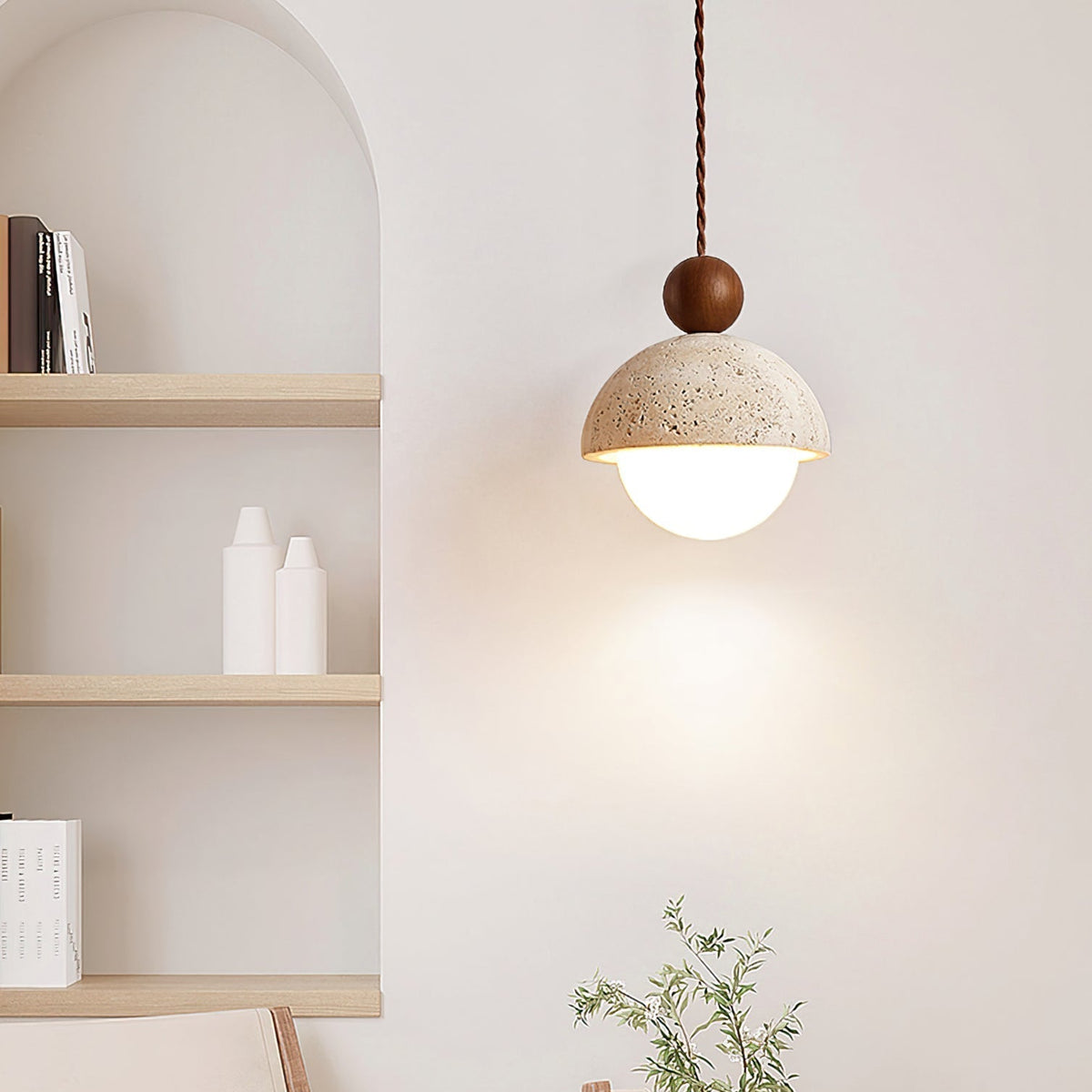Vairo Travertine Dome Pendant Light lit beside an arched alcove and open shelving