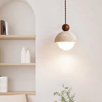 Vairo Travertine Dome Pendant Light lit beside an arched alcove and open shelving