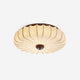 Larso pleated fabric ceiling light on a plain background showing the cream lotus-shaped shade and walnut wood canopy
