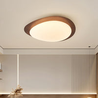 Quisto Pebble Walnut Ceiling Light on a pale ceiling above a neutral interior