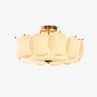 Meho shell ceiling light on a white background, overlapping opal glass discs on a brass frame