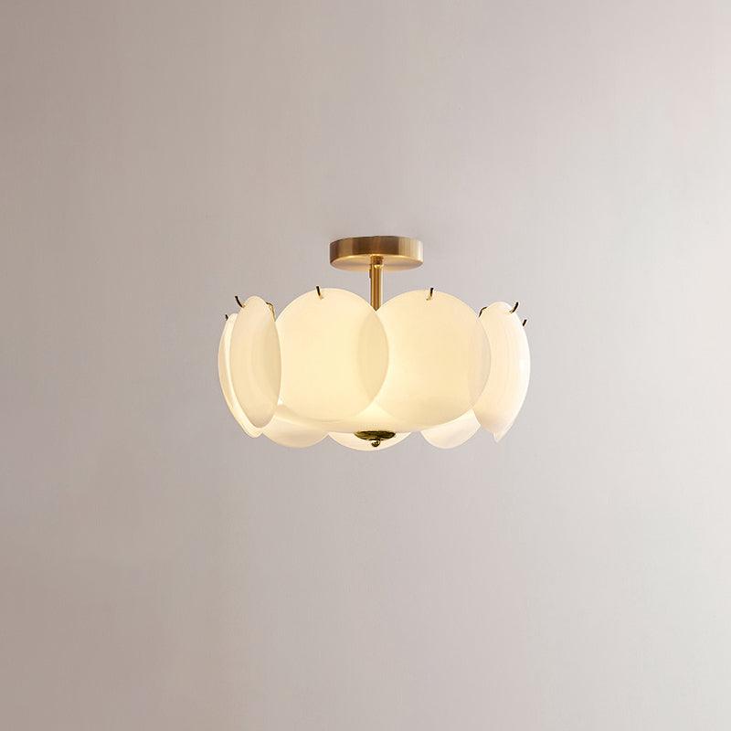 Meho shell ceiling light shown unlit on a brass stem against a plain wall