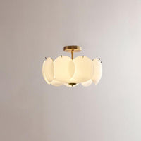 Meho shell ceiling light shown unlit on a brass stem against a plain wall