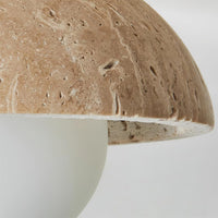 Detail of the natural travertine surface pores on the Isven ceiling light