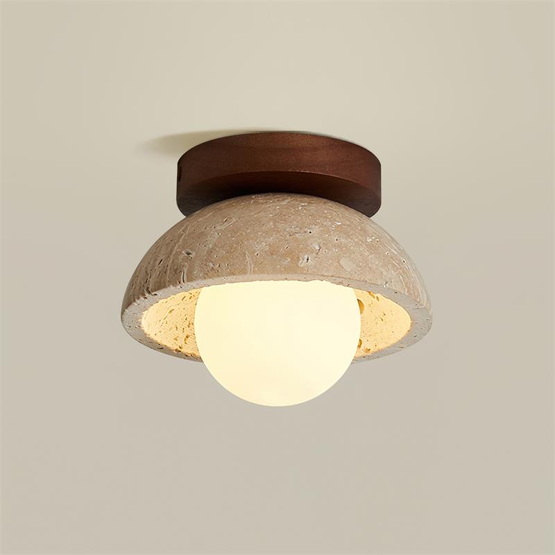 Isven ceiling light lit, showing the opal glass globe under the travertine dome