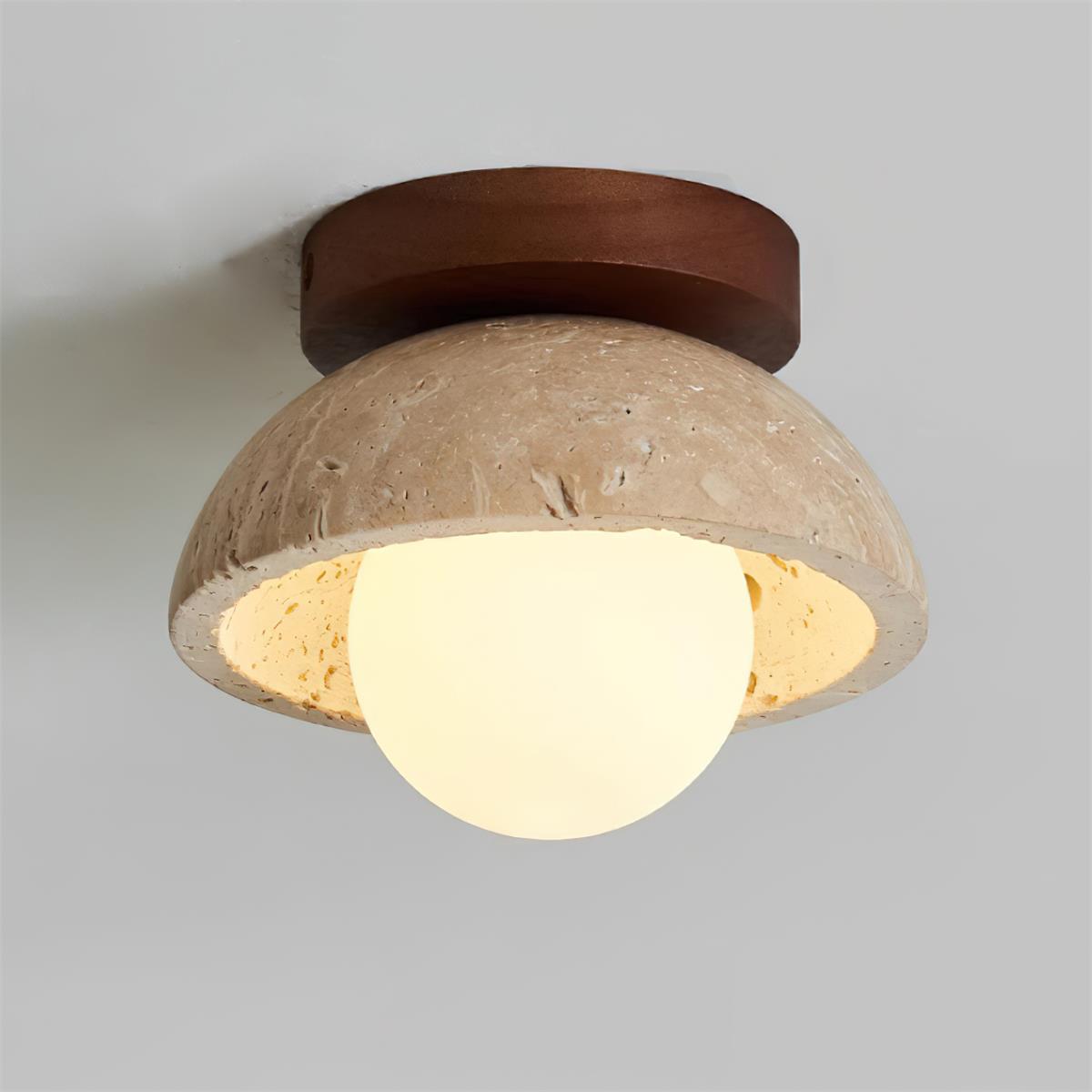 Angled view of the Isven travertine ceiling light switched on