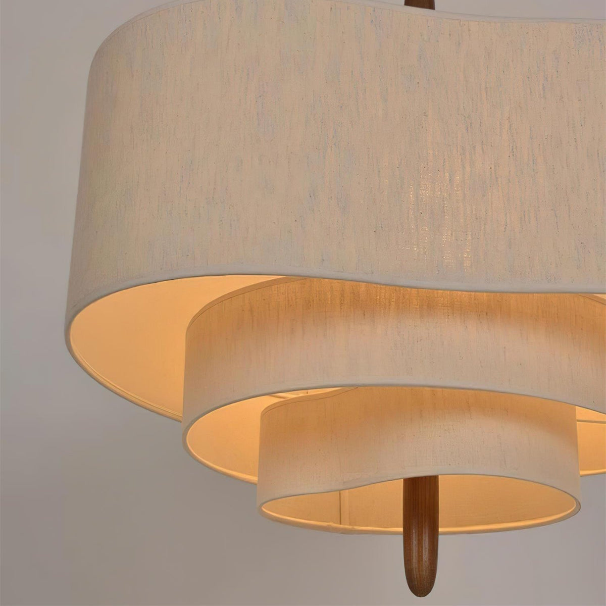 Close-up of the Verda Fabric Drum Pendant Light tiered fabric diffusers and wooden centre stem