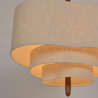 Close-up of the Verda Fabric Drum Pendant Light tiered fabric diffusers and wooden centre stem