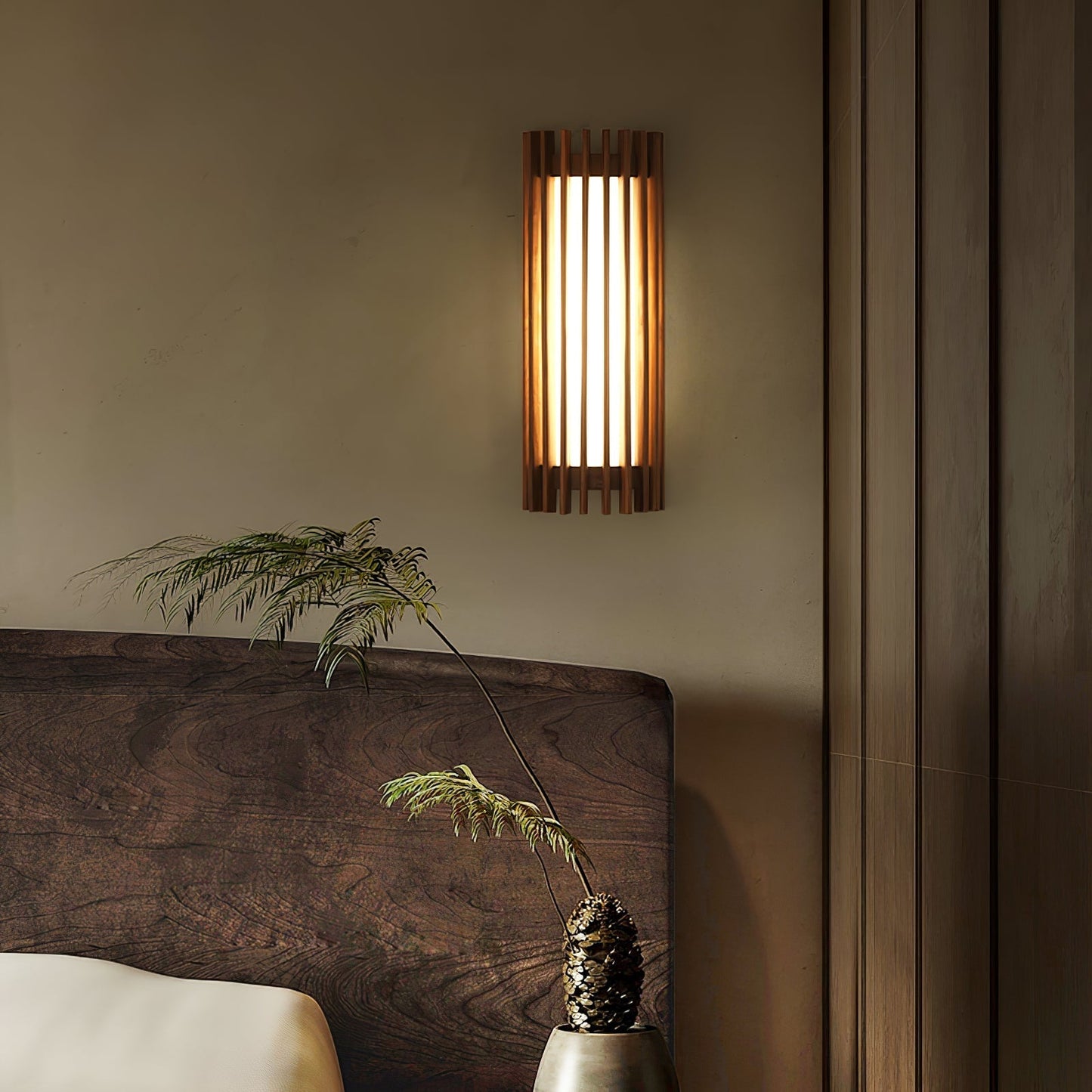 Neyro wall light lit beside a wooden headboard in a bedroom