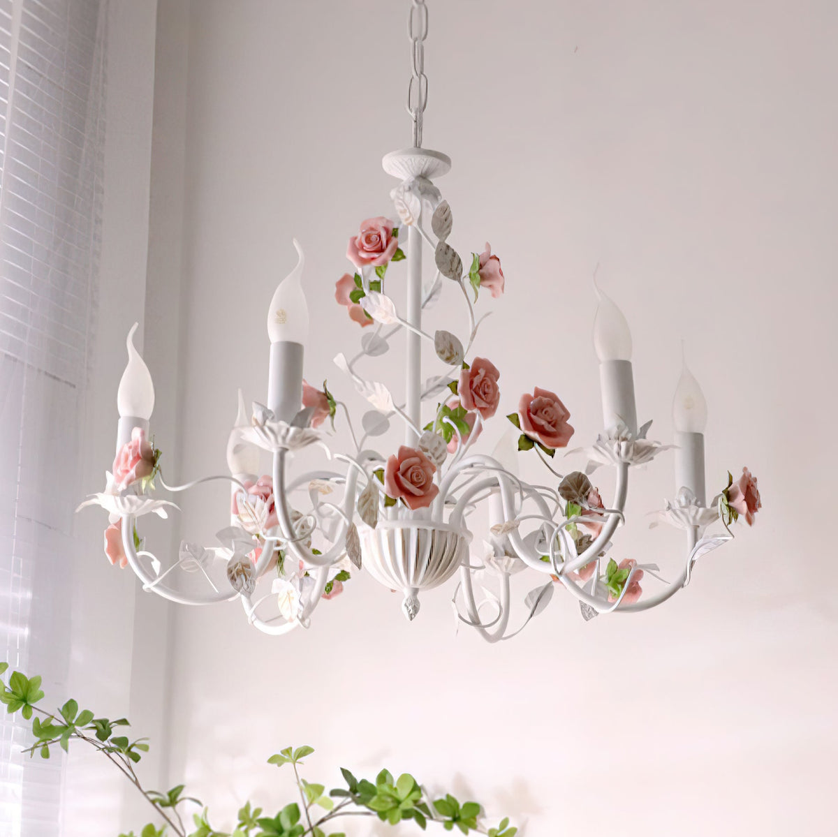 Rosven floral chandelier illuminated in bright room near window