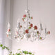 Rosven floral chandelier illuminated in bright room near window