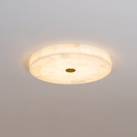 Cirra round alabaster ceiling light 3/4 angle view warm ambient light