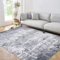 Marlo rug in a bright living room on herringbone oak flooring beside a pale grey sofa
