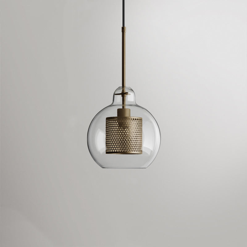 Lockhone Hesso globe pendant light in gold with a clear glass shade on a plain background