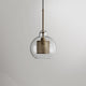 Lockhone Hesso globe pendant light in gold with a clear glass shade on a plain background
