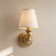 Ruva fabric shade wall light in brass with a white tapered shade on a plain background