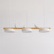 Clifo bird branch linear pendant light on a plain background, natural wood bar with three white disc shades and three cream ceramic birds