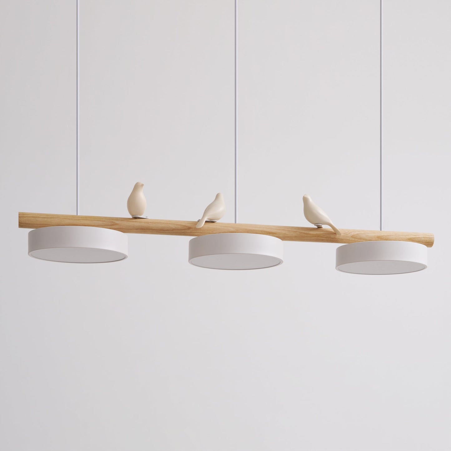 Side view of the Clifo pendant light showing the ceramic birds perched along the natural wood bar