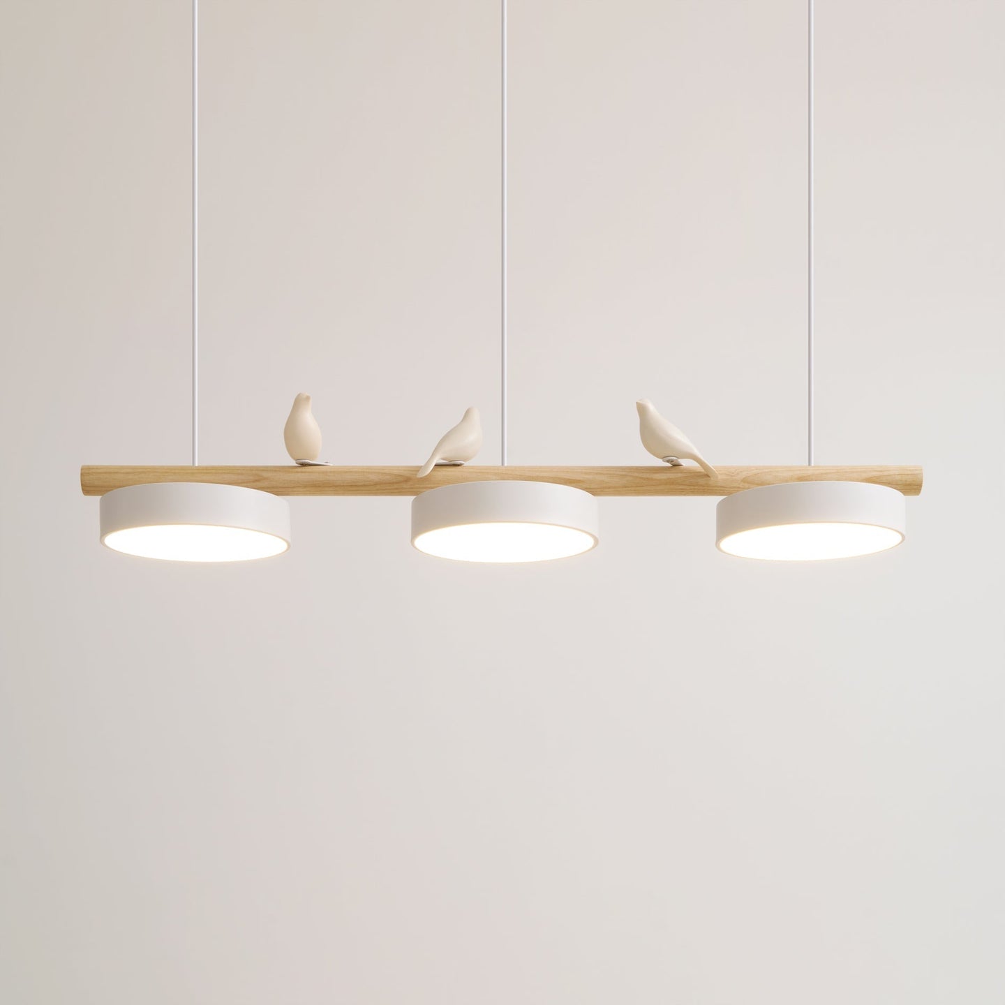 Clifo linear pendant light lit against a plain wall, three white discs fixed flush under the wooden branch bar