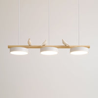 Clifo linear pendant light lit against a plain wall, three white discs fixed flush under the wooden branch bar
