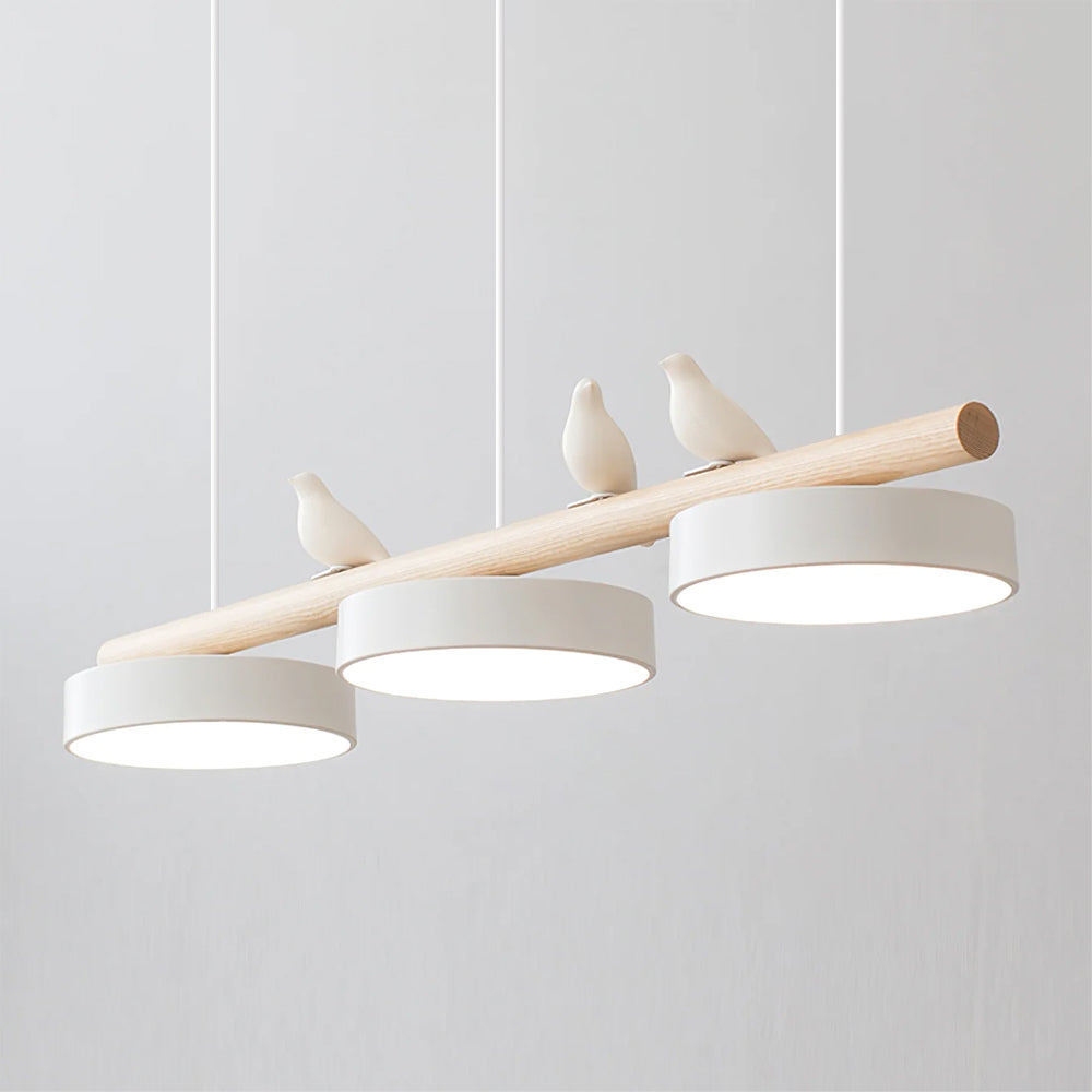 Angled close view of the Clifo pendant light switched on, showing the warm glow from the three white disc shades