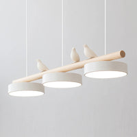 Angled close view of the Clifo pendant light switched on, showing the warm glow from the three white disc shades