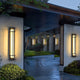 Rayo alabaster wall lights flanking a garden entrance in the evening