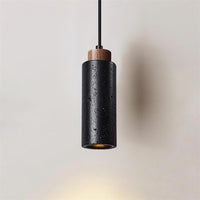 Basalo black travertine cylinder pendant light with wood collar on a plain background