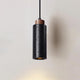 Basalo black travertine cylinder pendant light with wood collar on a plain background