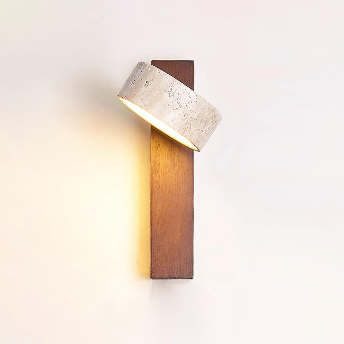 Nydo travertine wall light switched on, casting a warm glow down the walnut beam