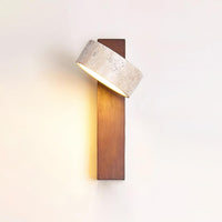 Nydo travertine wall light switched on, casting a warm glow down the walnut beam