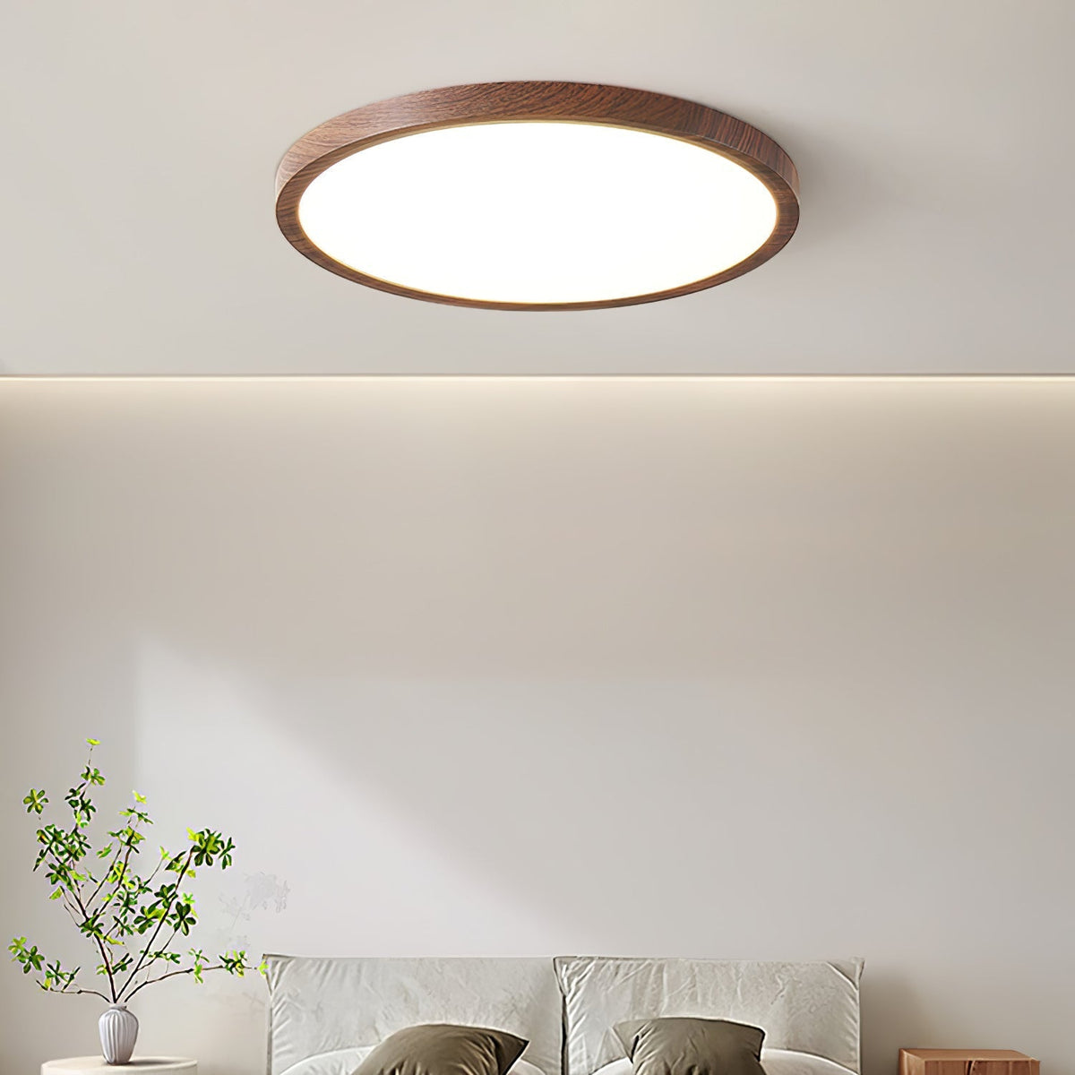 Ivero Ultra-Slim Ceiling Light lit above a bed in a bright neutral bedroom
