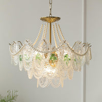 Close view of the Delvi chandelier gold rosette canopy, pearl strands and three tiers of textured glass panels