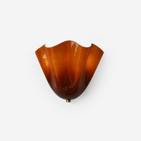 Sefta curved shade wall light in amber glass, fan shaped shade with a rippled top edge, on a plain white background