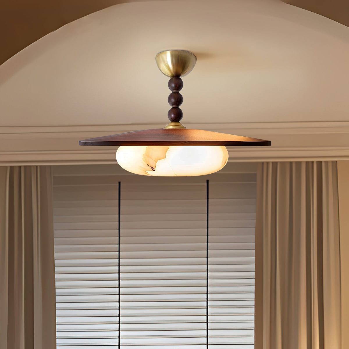 Walo Walnut Alabaster Effect Ceiling Light lit under a plaster archway beside a window