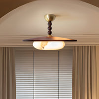 Walo Walnut Alabaster Effect Ceiling Light lit under a plaster archway beside a window