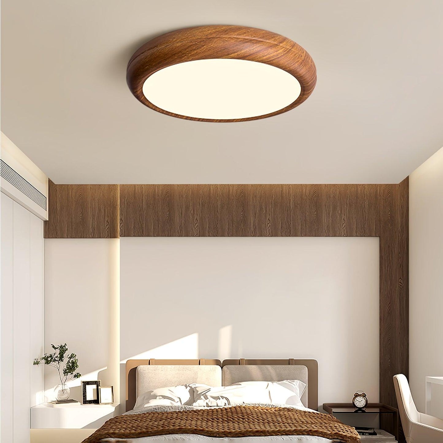 Greno round ceiling light in walnut wood grain above a bed with a wood panelled wall