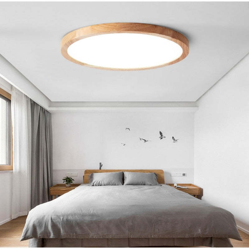 Aveno flush mount ceiling light fitted above a bed in a bright white bedroom