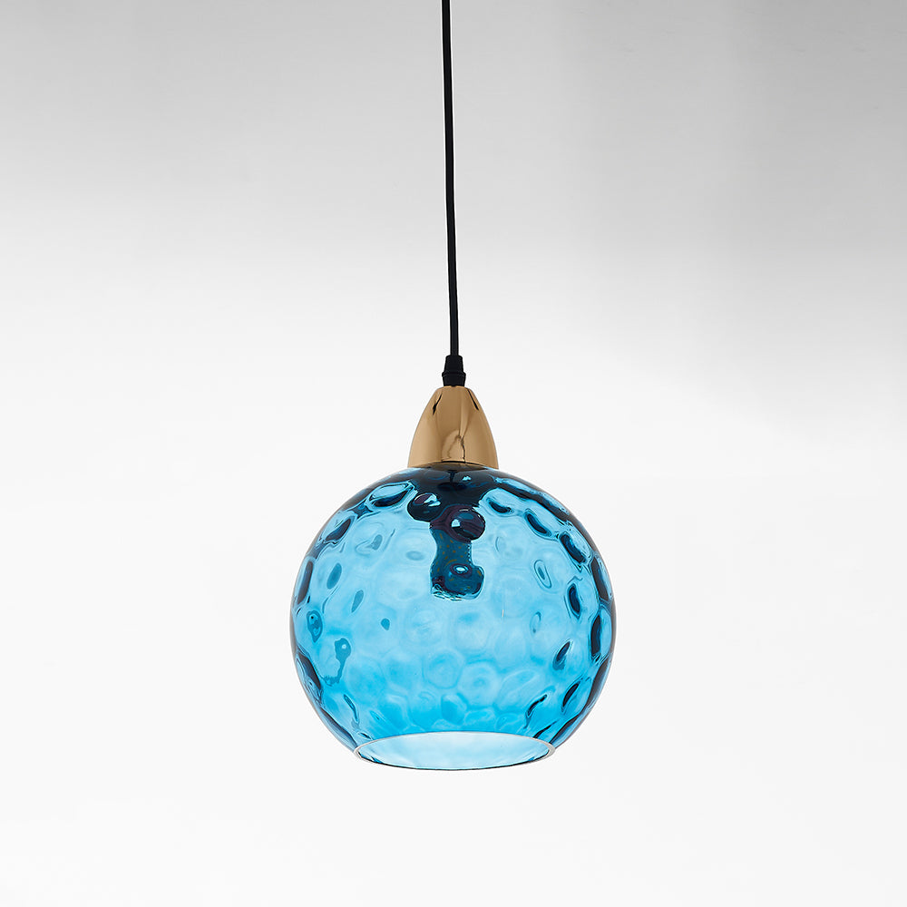Riplo blue ripple glass pendant light with brass lamp holder and black cord on a plain white background