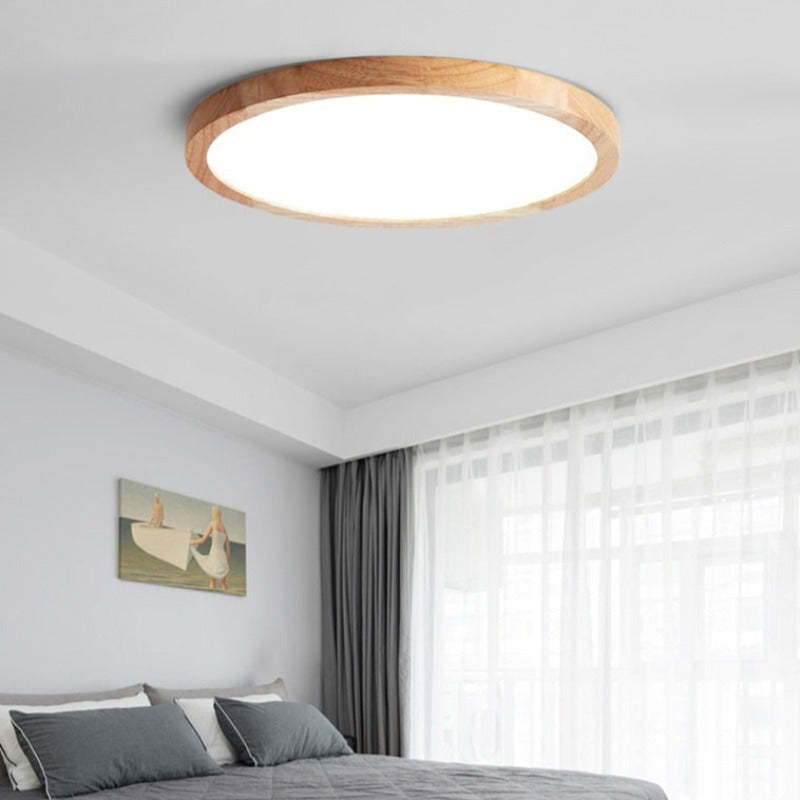 Aveno wood and acrylic ceiling light on a low bedroom ceiling beside a curtained window