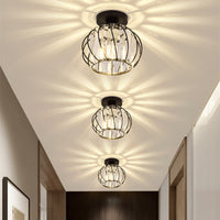 Row of three Relia black ceiling lights casting starburst patterns down a hallway