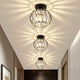 Row of three Relia black ceiling lights casting starburst patterns down a hallway