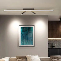 Vixa ceiling bar above a sofa with both spot heads washing light onto a framed picture on the wall