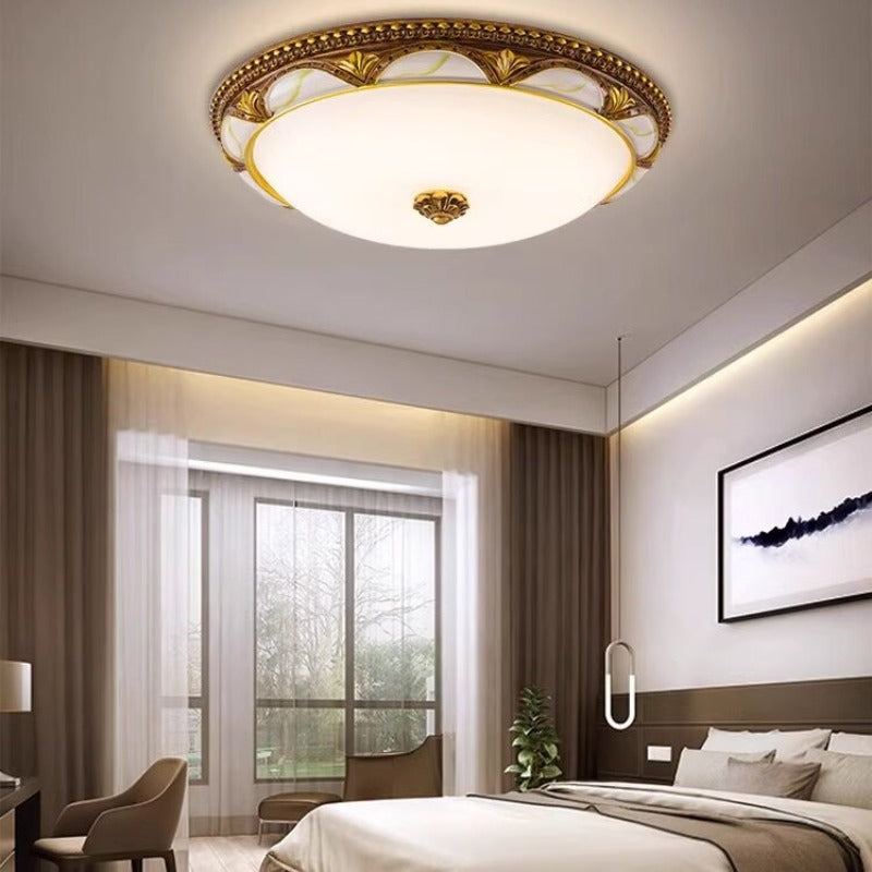 Epora Antique Brass Ceiling Light lit on the ceiling of a traditional bedroom
