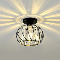 Close-up of the Relia black ceiling light lit with warm light through crystal panels