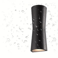 Black Kestro Torch outdoor wall light beaded with water droplets, showing the weather-resistant coating