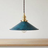 Pepa cone pendant light hanging above a pale oak kitchen worktop against an off-white wall