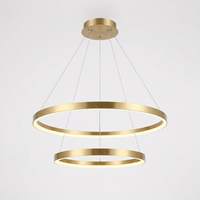 Remo Twin-Ring Pendant Light in brushed gold on a plain white background, showing the 60 cm upper ring and 40 cm lower ring on wire suspension